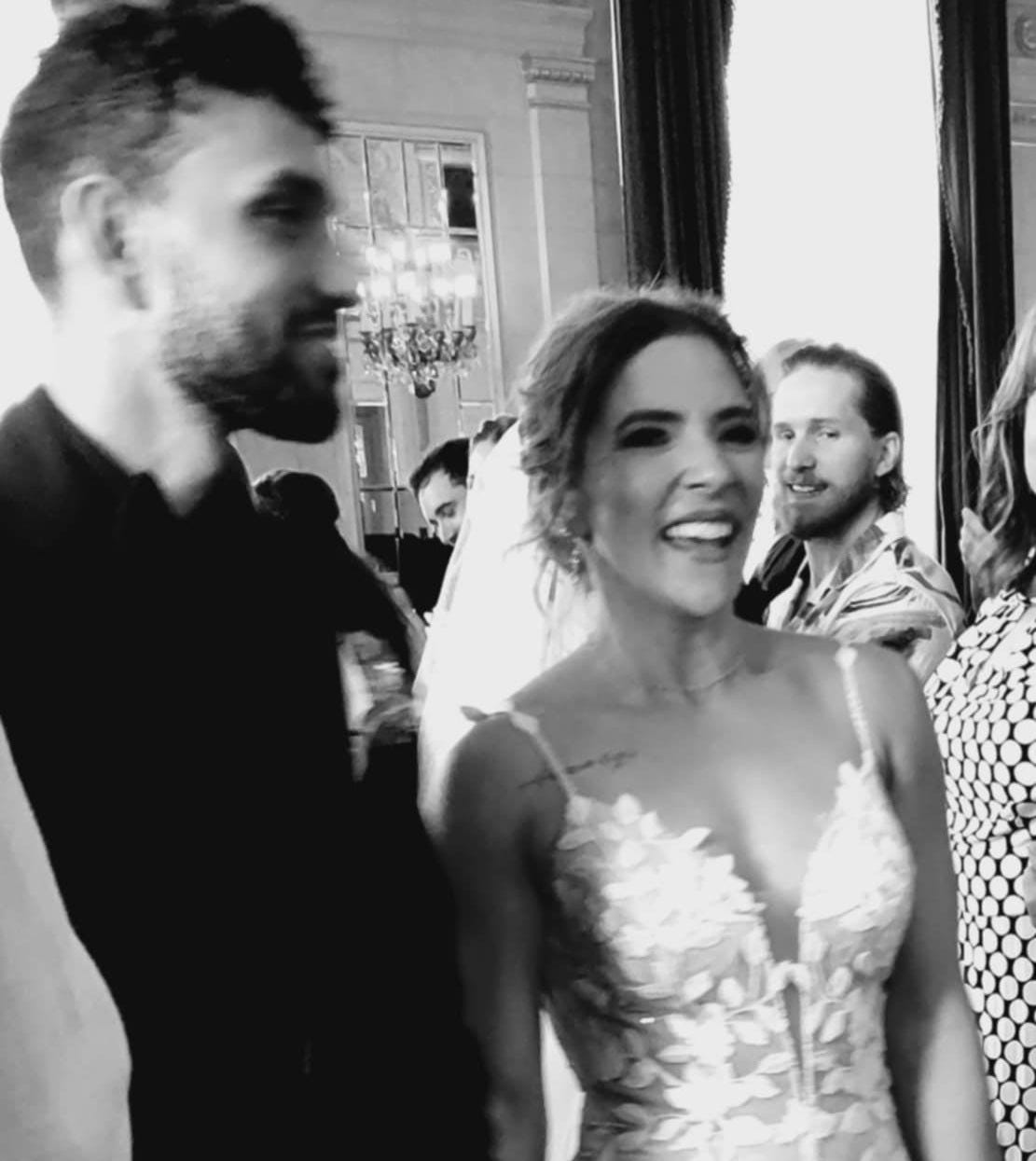 Alex Willkie wearing black tuxedo next to newlywed wife, Kelsey Schaefer, wearing wedding dress. Alex Willkie wearing black tuxedo next to newlywed wife, Kelsey Schaefer, wearing wedding dress.