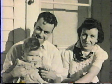 A two-year-old girl walking, parents holding a 1-year-old, and mom pushing a baby carriage in the late 1930s