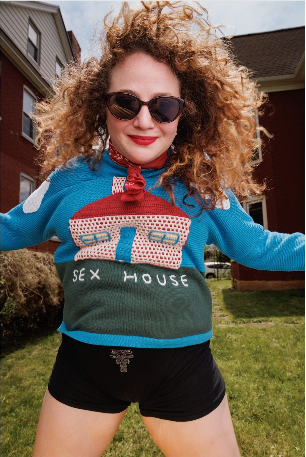 A smiling Jennie Egerdie of BEST PARTY, WORST HOUSE wearing red lipstick and sunglasses outside A smiling Jennie Egerdie of BEST PARTY, WORST HOUSE wearing red lipstick and sunglasses outside