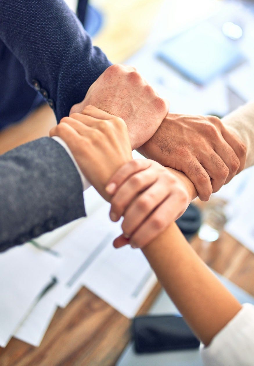 person in black long sleeve shirt holding persons hand