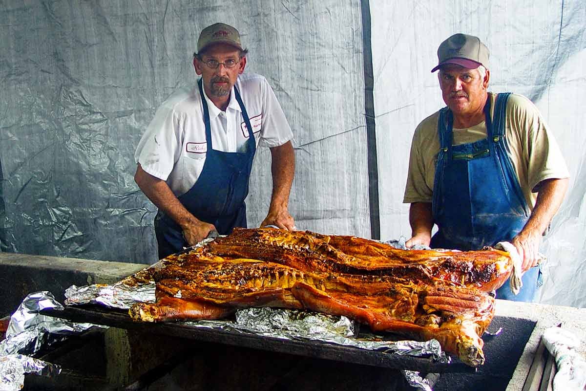 Ricky Parker positioning a slab of whole hog barbecue Ricky Parker positioning a slab of whole hog barbecue