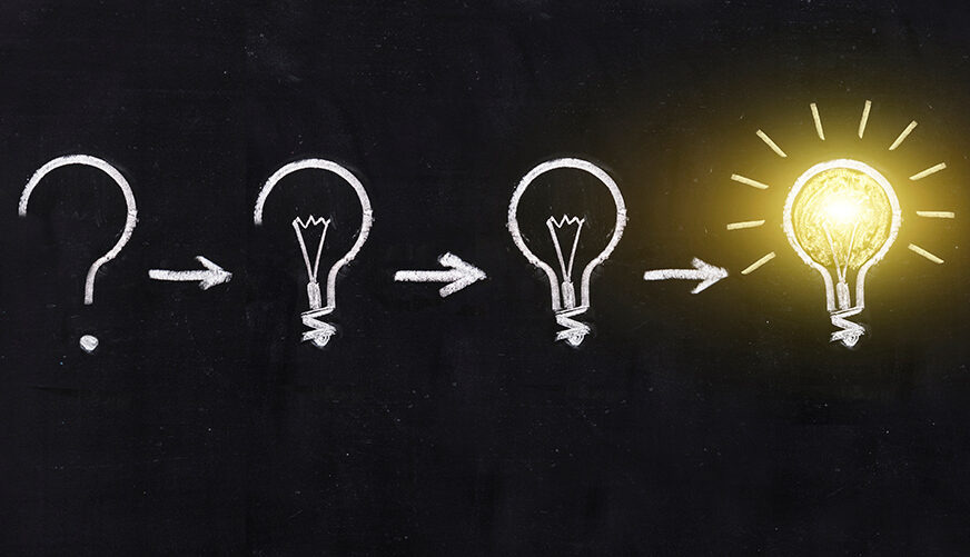 Black and white light bulb using doodle art on chalkboard backgr