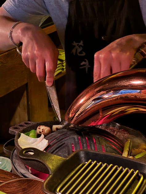 Left, image of a woman cooking over a bucket of coals. Middle, close-up of women's hands preparing food. Right, shot of the interior of a small restaurant with wood paneled walls.
