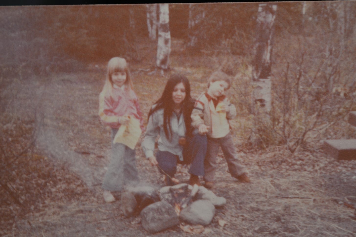 Mary of Anchorage Memories roasting hot dogs near a creek in Chugiak, Alaska.