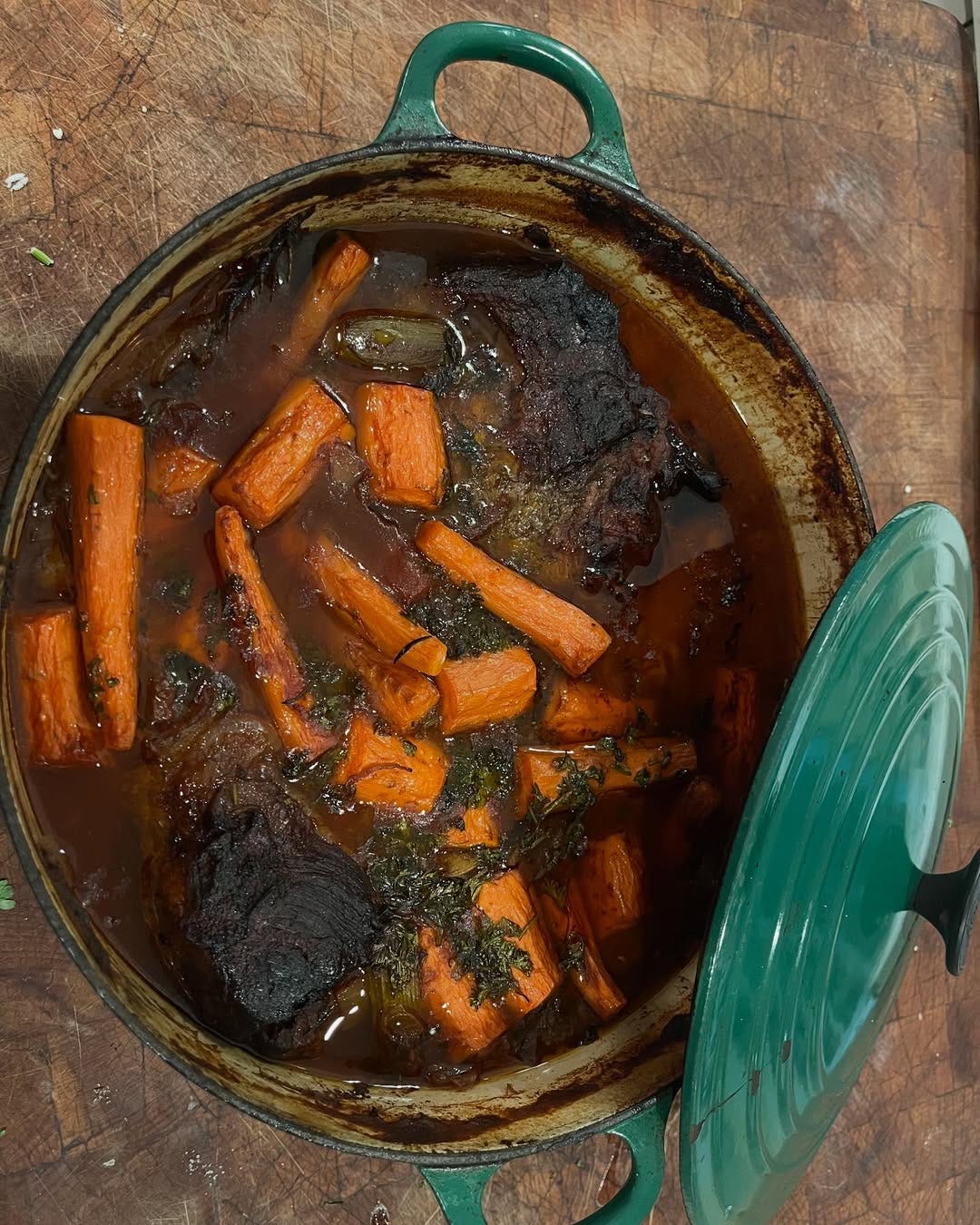 Joan's Passover brisket and carrots cooking in a green dutch oven Joan's Passover brisket and carrots cooking in a green dutch oven