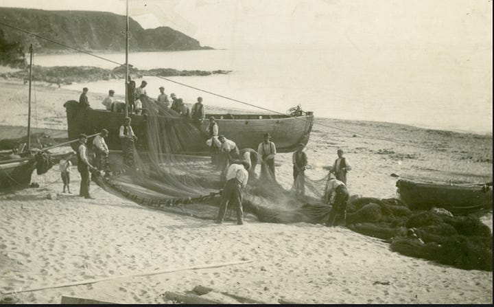 Images from the the Museum of Cornish Life's photographic collection, used with permission. 1. “Cornish fishermen on a bench, Salt Cellar Hill, Porthleven, 1920s-1930s.” 2. “Seagulls by Fishing Boat, Cadgwith, 1928” Photographer Dyott Darwell, Helston. 3. “Pilchard Seining at Gunwalloe, 1890” A huer with bushes is signalling the location of the shoals of pilchards to the seine boats out at sea. 4. “Fishing at Gunwalloe, 1899” 5. Cornish Fishermen at Mevagissey, about 1920 Two Cornish fishermen in conversation with a young lady.