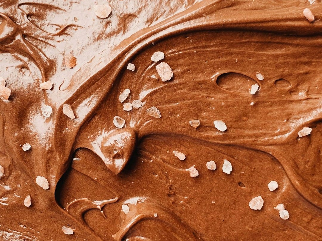 a close up of a chocolate frosted cake
