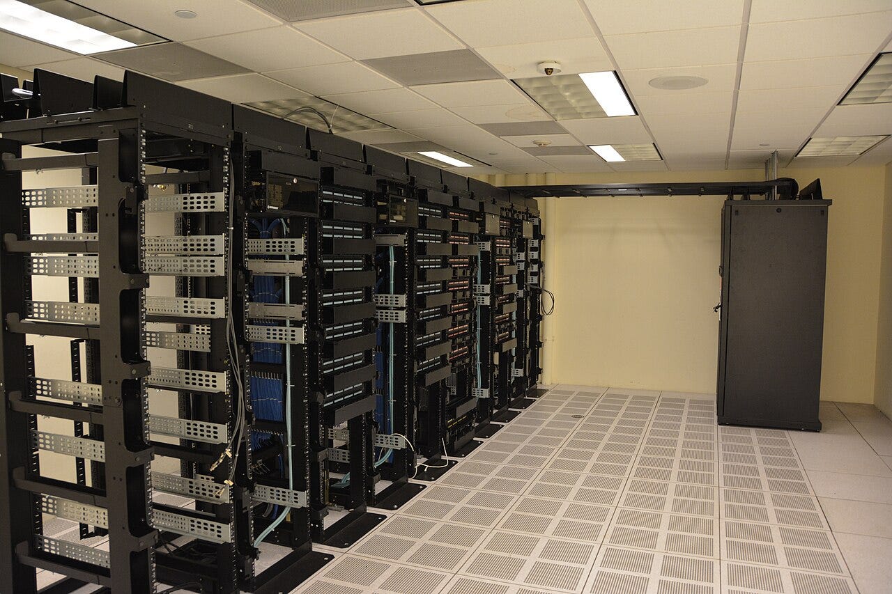AI revenue — Data center server racks, photo by Carl Lender / CC BY 2.0 (Wikimedia Commons) AI revenue — Data center server racks, photo by Carl Lender / CC BY 2.0 (Wikimedia Commons)