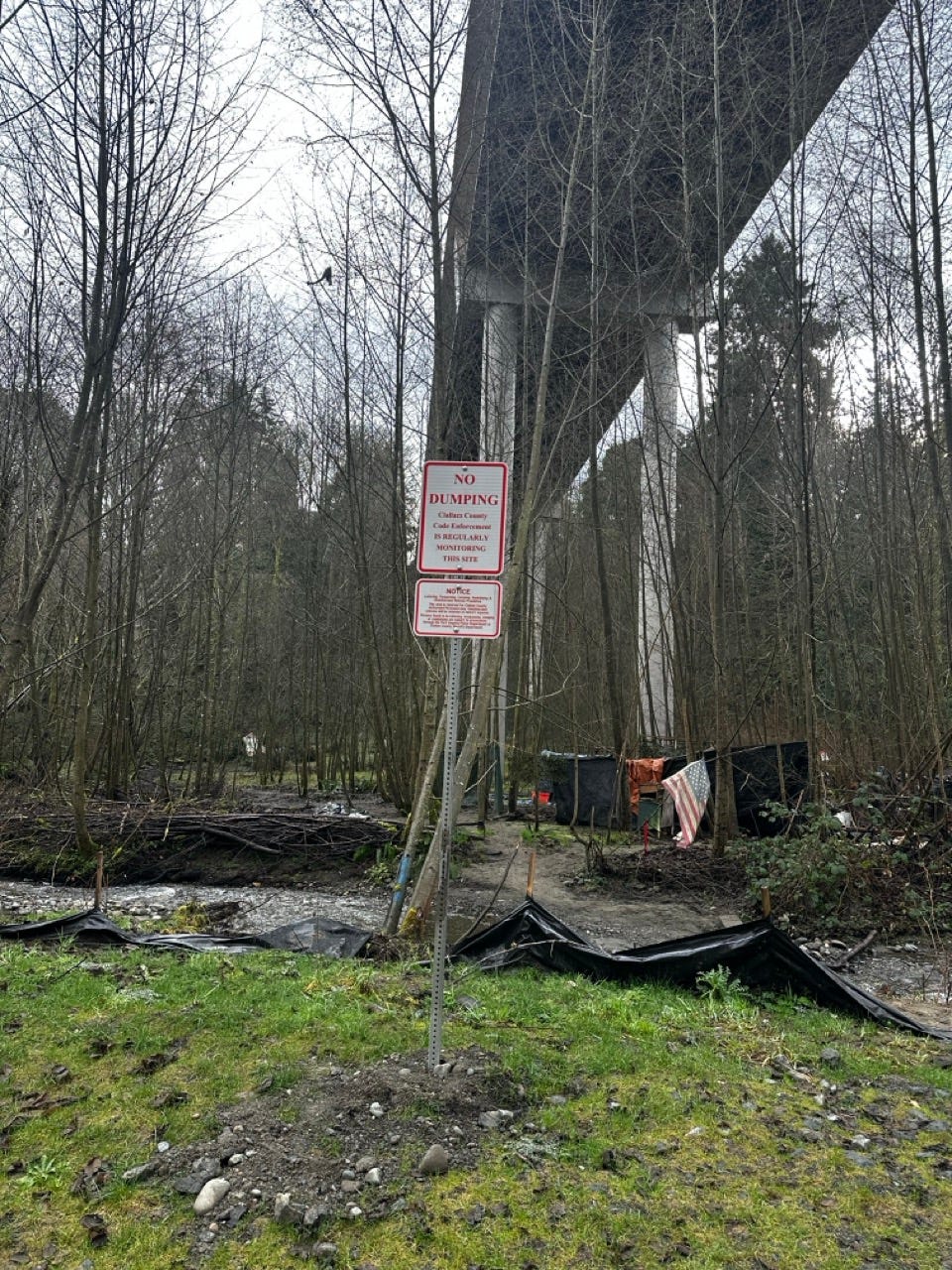 A sign in the woods

Description automatically generated