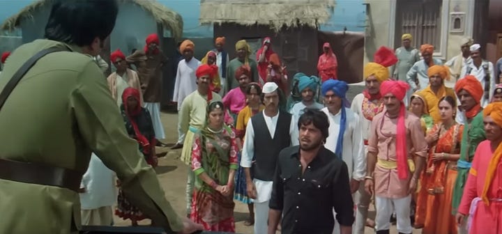 snapshot from the movie Rajput where the rebel dacoits are seen surrendering their guns to the police