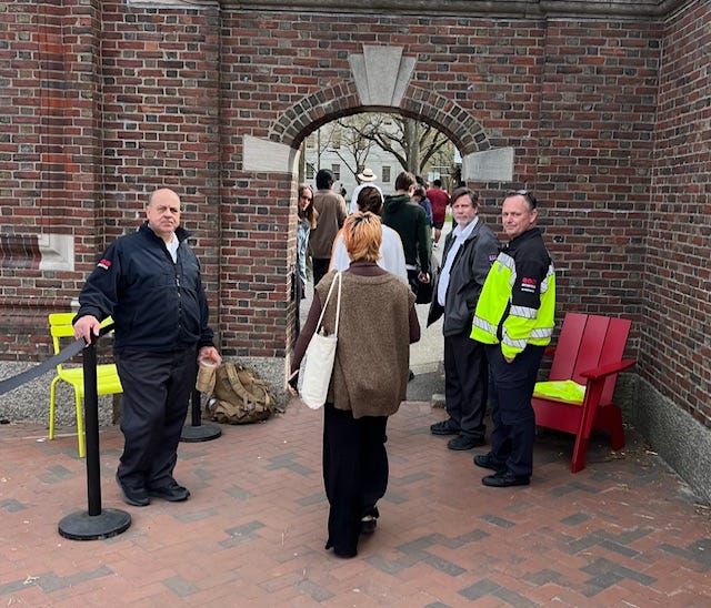 A group of people standing in front of a brick archway

Description automatically generated