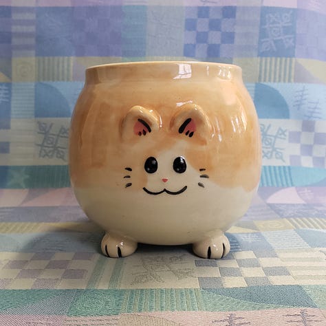 Kitty shaped mugs from different angles.