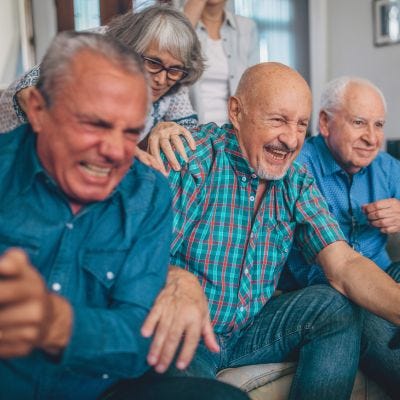 A group of senior men playing nintendo switch for older adults