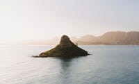 A small island in a calm bay.