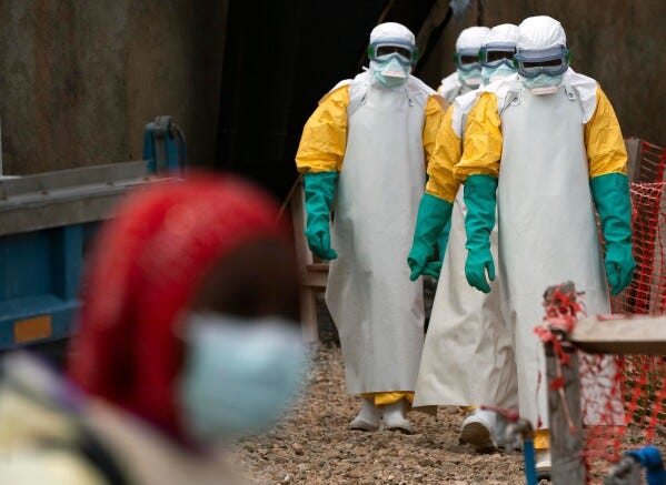 Health workers dressed in protective gear begin their shift at an Ebola treatment center in Beni, Congo, July 16, 2019. (AP Photo/Jerome Delay, File)