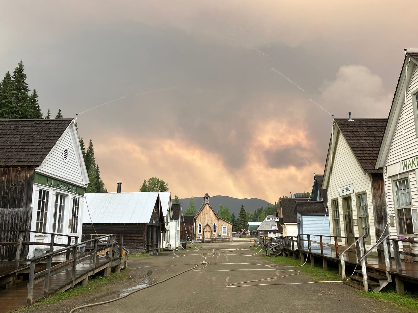a row of wooden structures in barkerville with sprinklers attached to the roofs a row of wooden structures in barkerville with sprinklers attached to the roofs