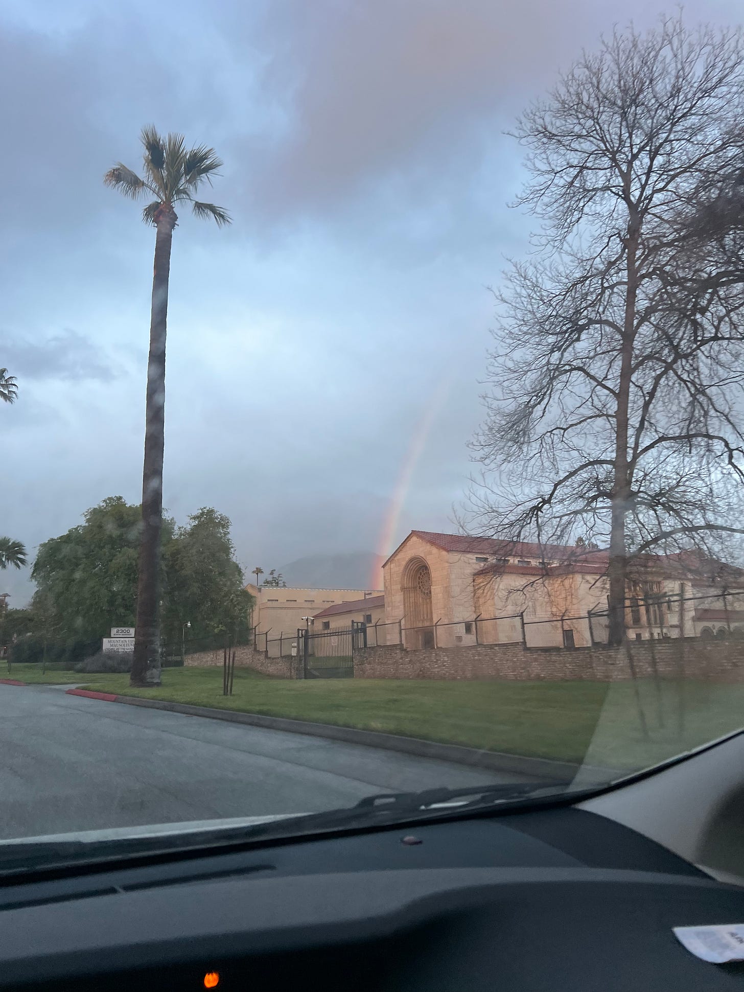 a rainbow hides in a smokey LA sky
