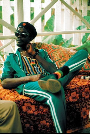 This may contain: a man sitting on top of a couch wearing a helmet