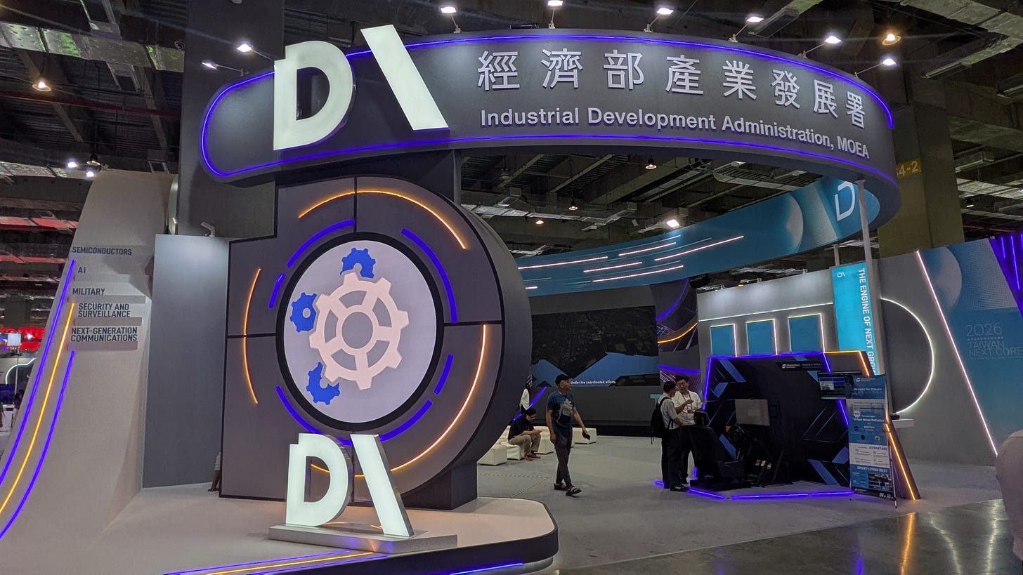 Booth for Taiwan’s Ministry of Economic Affairs Industrial Development Administration at COMPUTEX InnoVEX, with signs referencing semiconductors, AI, military applications, security and surveillance, and next-generation communications. Booth for Taiwan’s Ministry of Economic Affairs Industrial Development Administration at COMPUTEX InnoVEX, with signs referencing semiconductors, AI, military applications, security and surveillance, and next-generation communications.