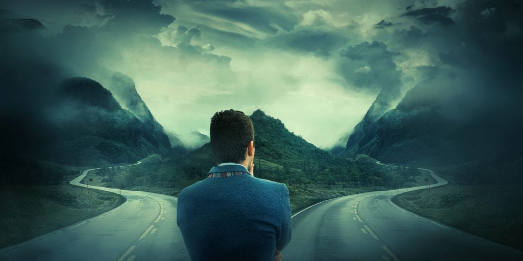 Man choosing between two roads Man choosing between two roads
