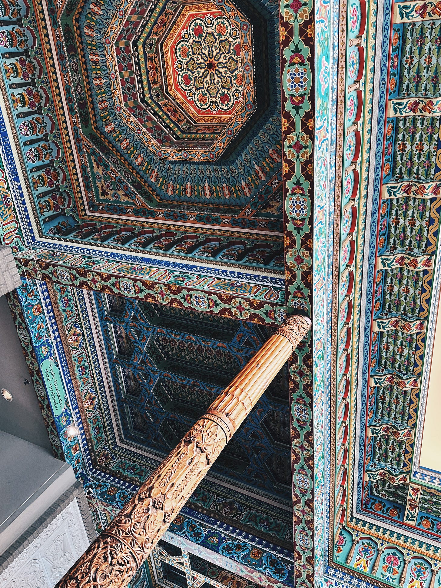 Hand-painted wooden ceiling and carved architectural details inside Boulder Dushanbe Teahouse near Denver, featuring Tajik craftsmanship Hand-painted wooden ceiling and carved architectural details inside Boulder Dushanbe Teahouse near Denver, featuring Tajik craftsmanship