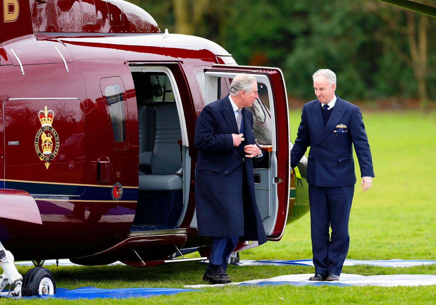 King Charles coming off his red helicopter