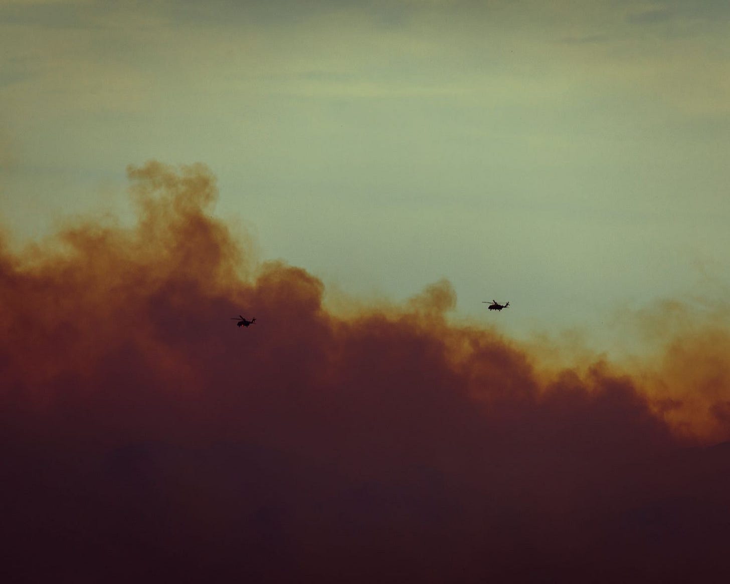 Helicopters fly through smoked out clouds Helicopters fly through smoked out clouds