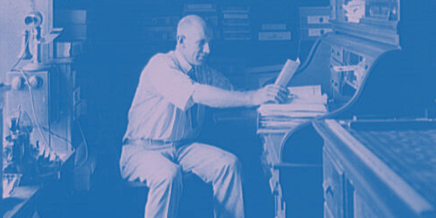 duotone blue and lavender colored edit on an old photograph of a man in business attire sitting at a desk looking at paperwork