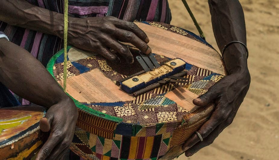 Two hands playing a traditional musical instrument Two hands playing a traditional musical instrument