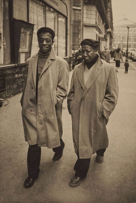 Three photos of black artists who found artistic solace in France. On the left is Josephine Baker arching her back, arm aloft in the air, covering in swooping feathers. She smiles off into the distance with a full face of make up. Next James Baldwin and Beauford Delaney walk in long trench coats side by side on the Paris streets. James is smiling and Beauford is intently listening. To the right is Loïs Mailou Jones painting in her studio. She paints a canvas that has its back to us. She has a tabby kitten on her shoulder.