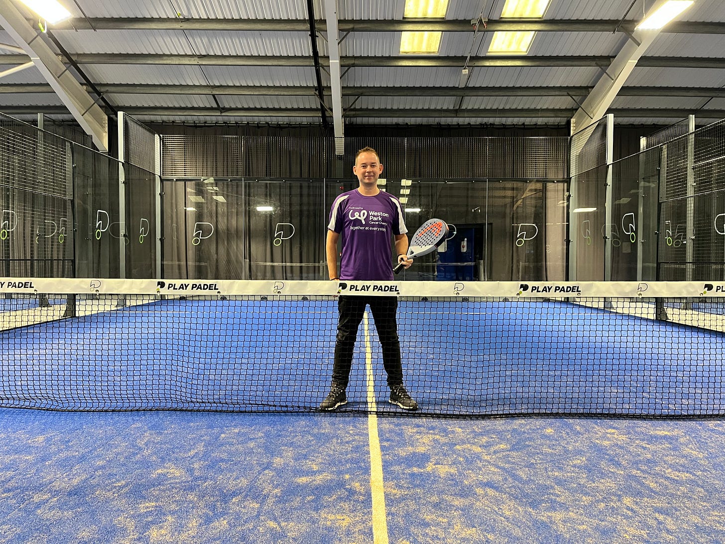 Andrew Lofthouse, stood on a padel court with a racket at Play Padel