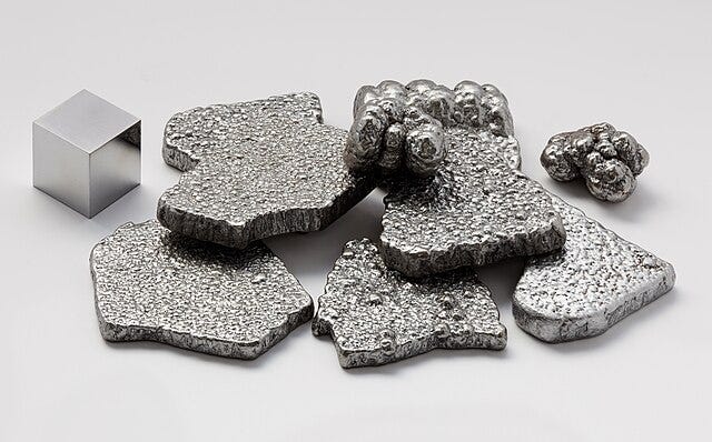 Different forms of iron: a shiny cube, pitted amorphous flat shapes of silver, and collections of iron 'bubbles'. Different forms of iron: a shiny cube, pitted amorphous flat shapes of silver, and collections of iron 'bubbles'.