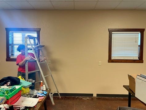 Photos of the gals painting, pressure washing, staining, and sorting laundry.