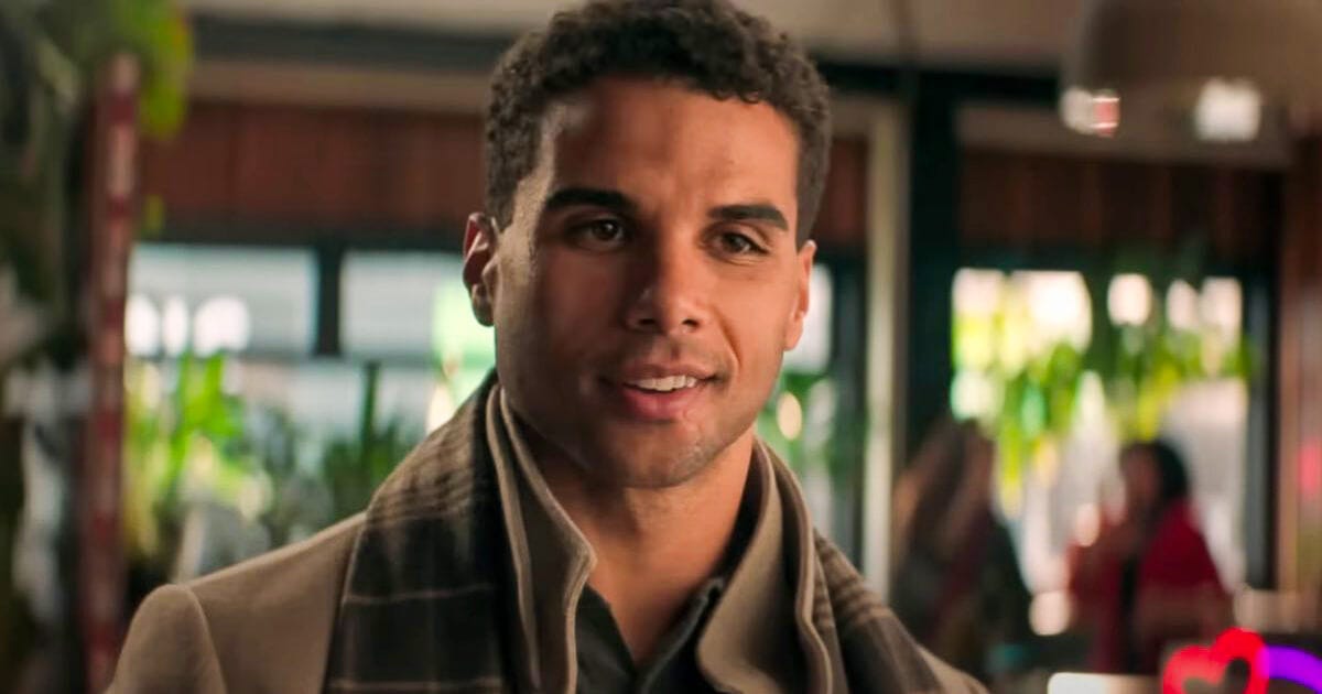 Mason Gooding flashes a charming smile during the couple’s coffee shop meet-cute in Heart Eyes.