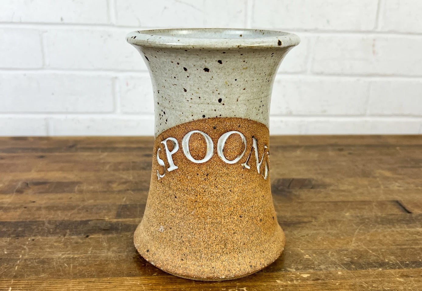 vintage utensil holder with SPOONS stamped into side.
