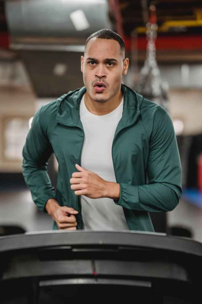 enduring man running fast on treadmill with constant progress enduring man running fast on treadmill with constant progress