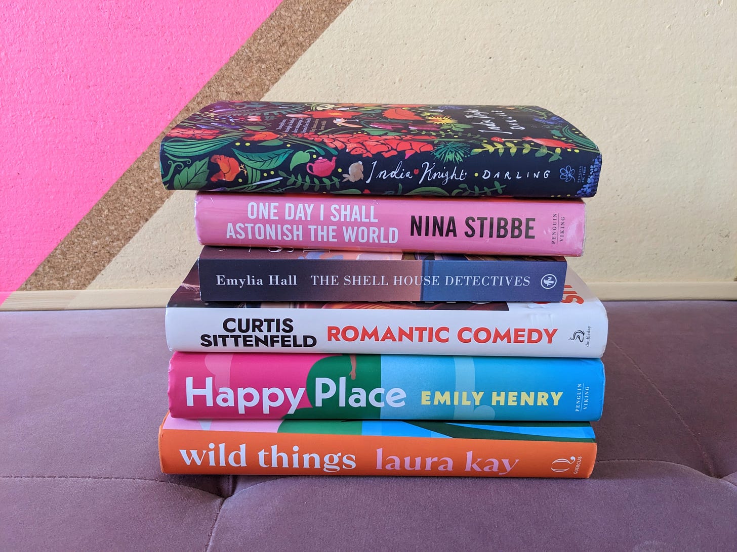 A stack of books against a colourful background