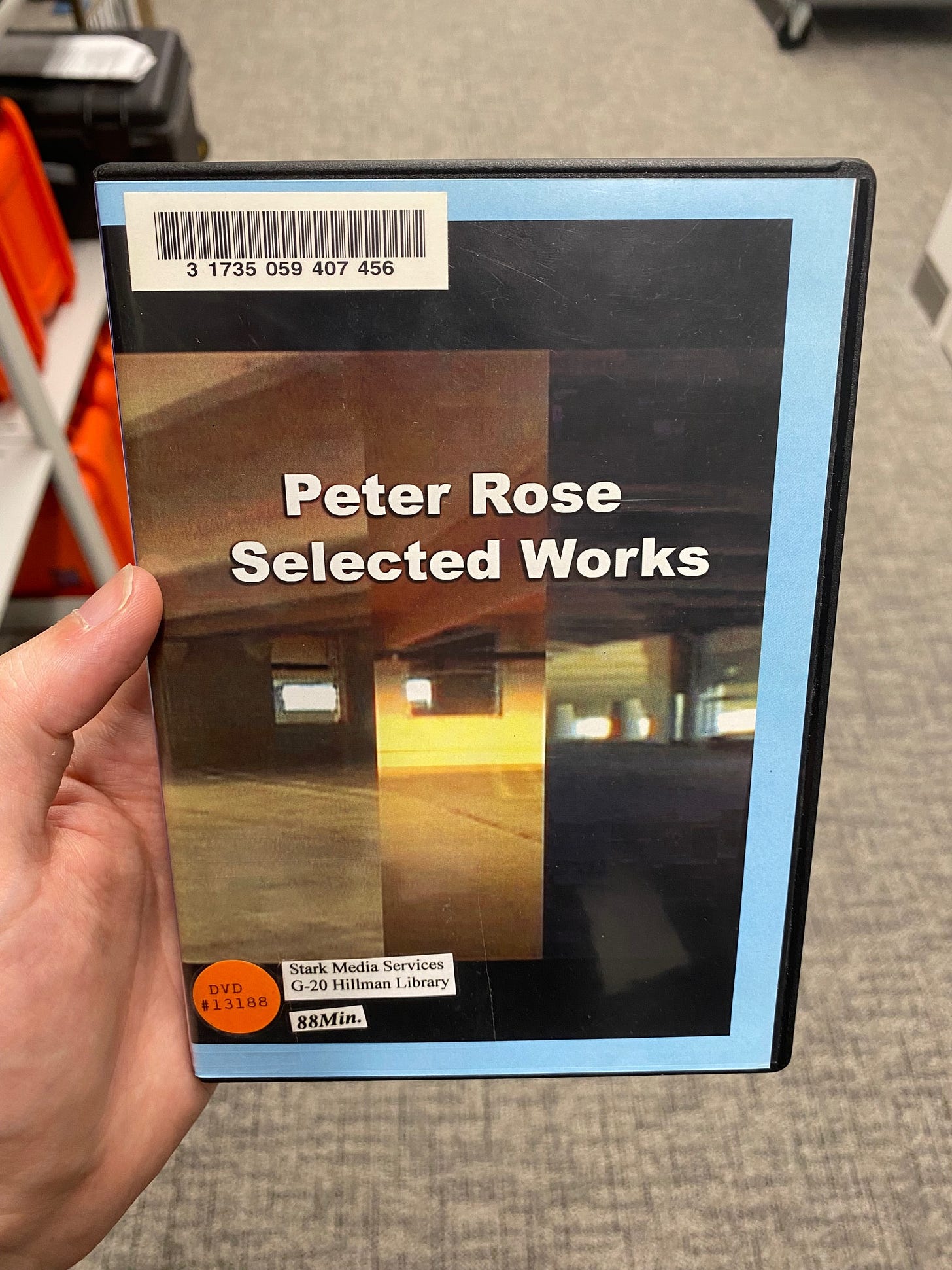 A DVD for Peter Rose Selected Works. The cover has fairly low-resolution shots of what appears to be a parking garage. “Peter Rose Selected Works” appears on the center of the cover in big bold white letters, maybe a bold Arial, with slight drop shadow—more or less WordArt vibes. No other text is on the cover except library cataloguing stickers.