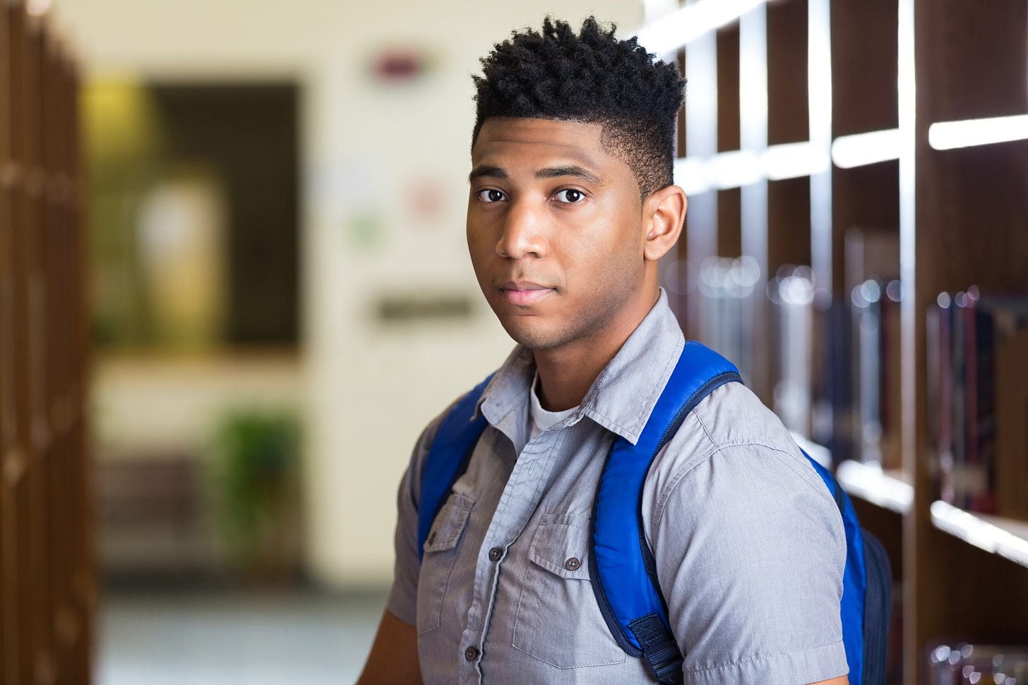 Serious African American high school boy in library | NNPA ESSA MEDIA  CAMPAIGN