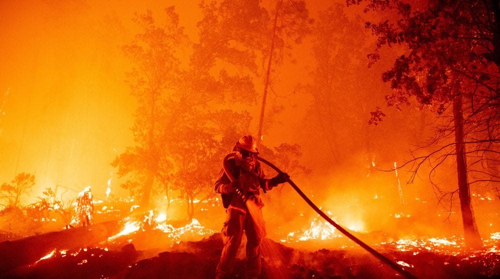 A firefighter battles flames approaching homes during the “Creek Fire” in Madera County, September 7, 2020 by Josh Edelson A firefighter battles flames approaching homes during the “Creek Fire” in Madera County, September 7, 2020 by Josh Edelson