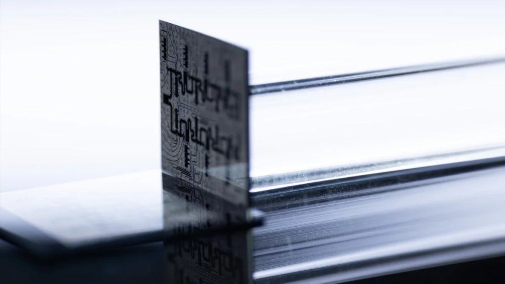 The pair of silicon microchips that compose the Ocelot logical-qubit memory chip.