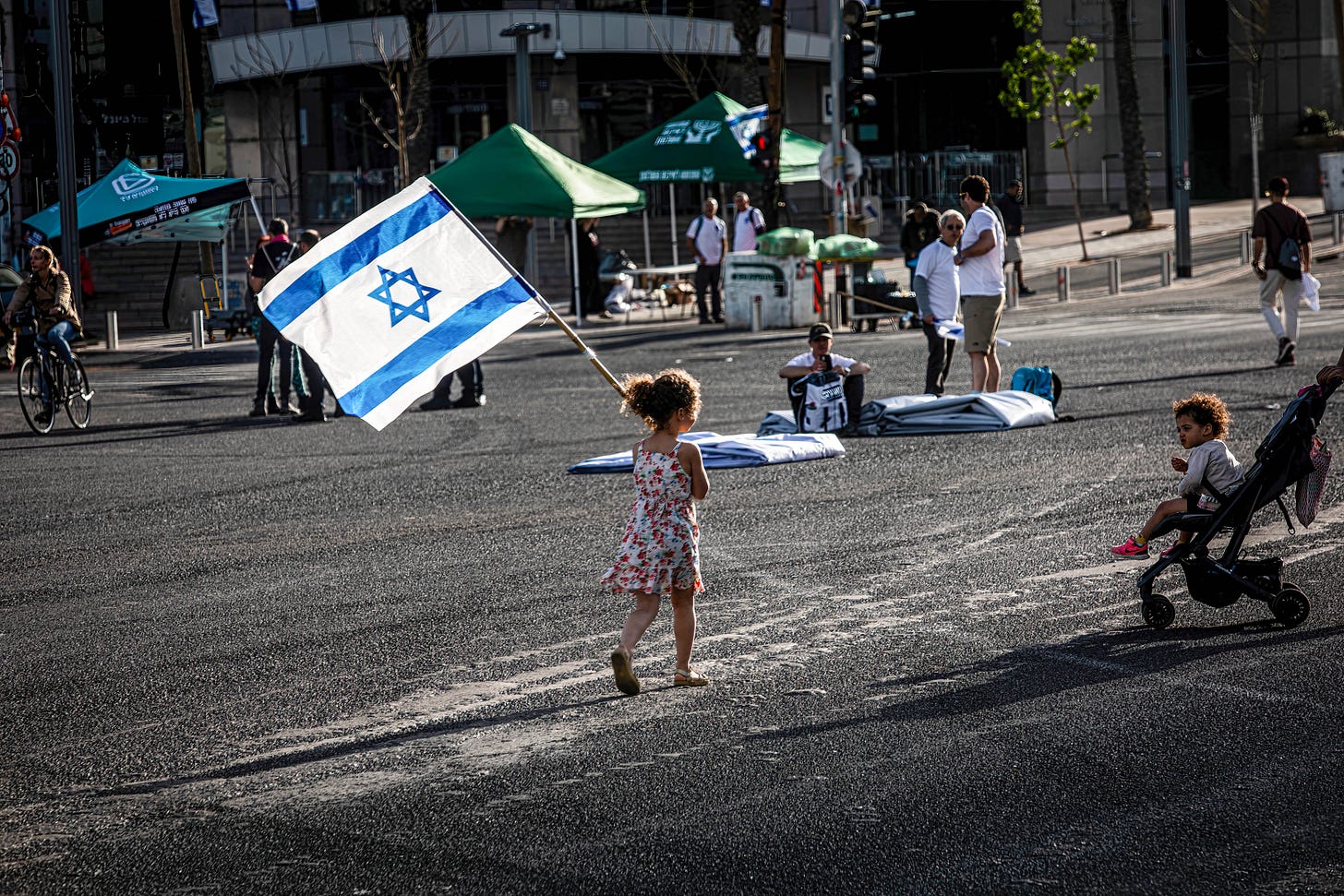 A girl walks with the Israeli flag prior to an anti-reform demonstration in Tel Aviv. (Photo by Eyal Warshavsky/SOPA Images/LightRocket via Getty Images.) A girl walks with the Israeli flag prior to an anti-reform demonstration in Tel Aviv. (Photo by Eyal Warshavsky/SOPA Images/LightRocket via Getty Images.)
