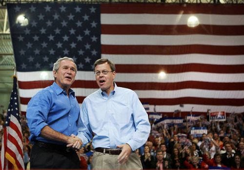 President George W. Bush shakes hands with US Senator Jim Talent 03 November 2006 at a campaign rally in Joplin, Missouri. Bush will spend the day...