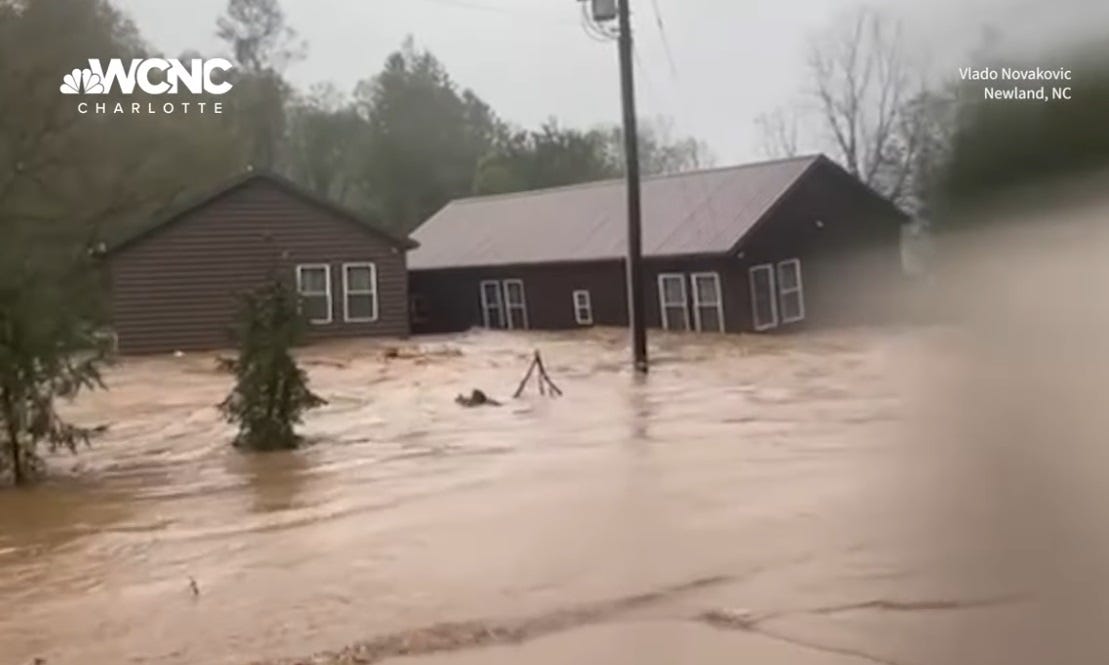 video screenshot of two houses, both torn off their foundations, colliding in a flooded river