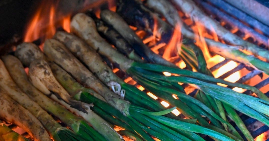 a bunch of sticks are cooking on a grill a bunch of sticks are cooking on a grill