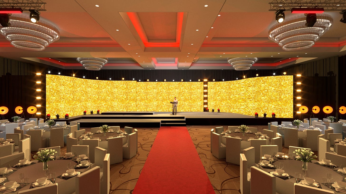 Eleganczna scenografia eventowa z ekranami LED w tle, czerwonym dywanem i aranżacją stołów bankietowych – przykład gotowego projektu multimedialnego dla gali firmowej.