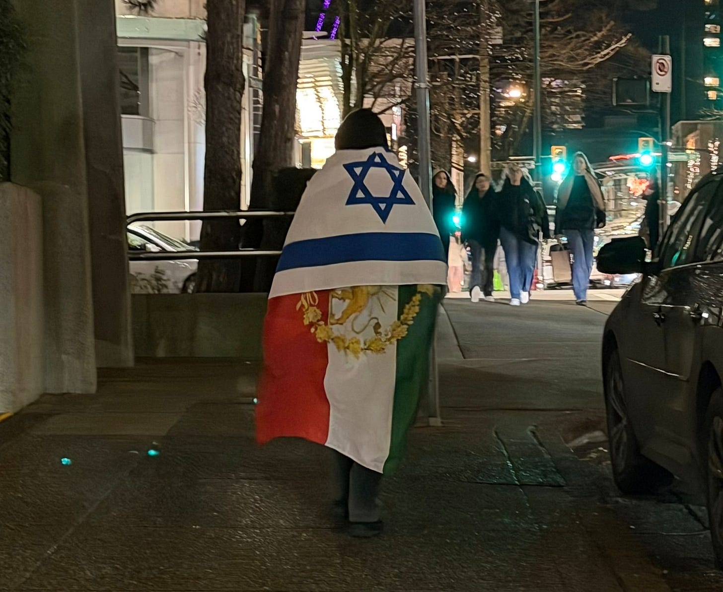 (A protester in downtown Vancouver. Image: Coastal Front.) (A protester in downtown Vancouver. Image: Coastal Front.)