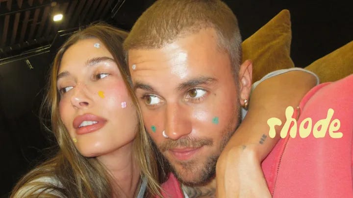 Hailey and Justin Bieber wearing colorful Rhode Spotwear blemish patches in mushroom and flower shapes, posing for a close-up beauty campaign photo with the Rhode logo. Hailey and Justin Bieber wearing colorful Rhode Spotwear blemish patches in mushroom and flower shapes, posing for a close-up beauty campaign photo with the Rhode logo.