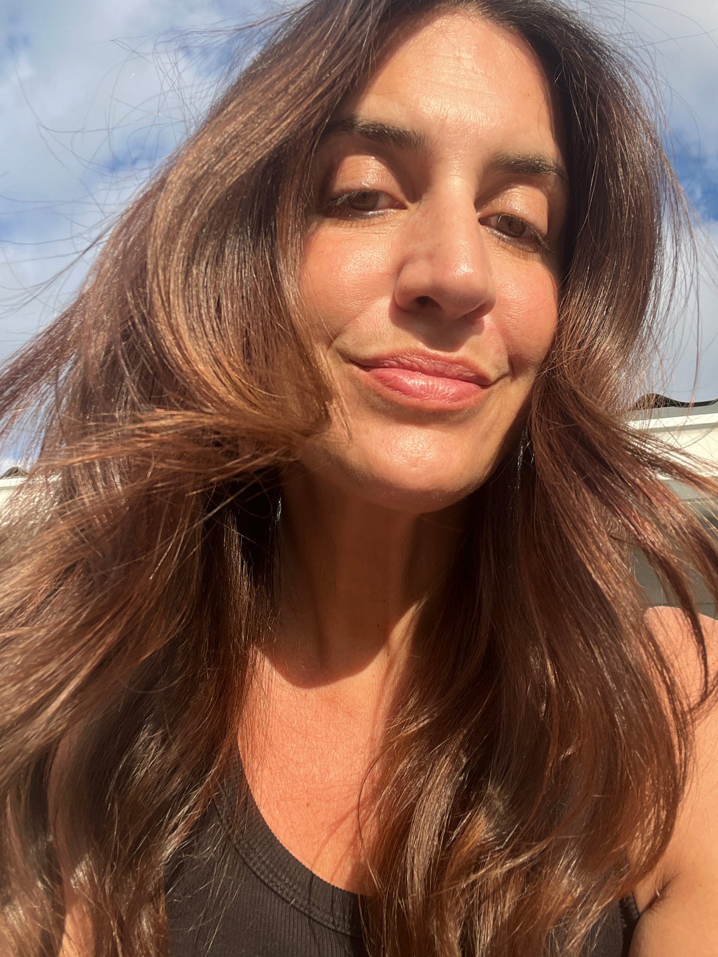 An unretouched, close-up selfie of Award Winning Beauty Editor and founder of The Beauty Ed® Donna Francis in Florida sunlight, showing the healthy density and shine of her natural hair.
