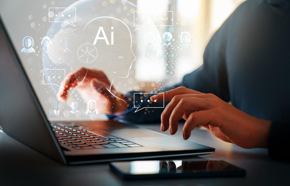 Photo of hands working on a laptop with AI iconography shown above the device. Photo of hands working on a laptop with AI iconography shown above the device.